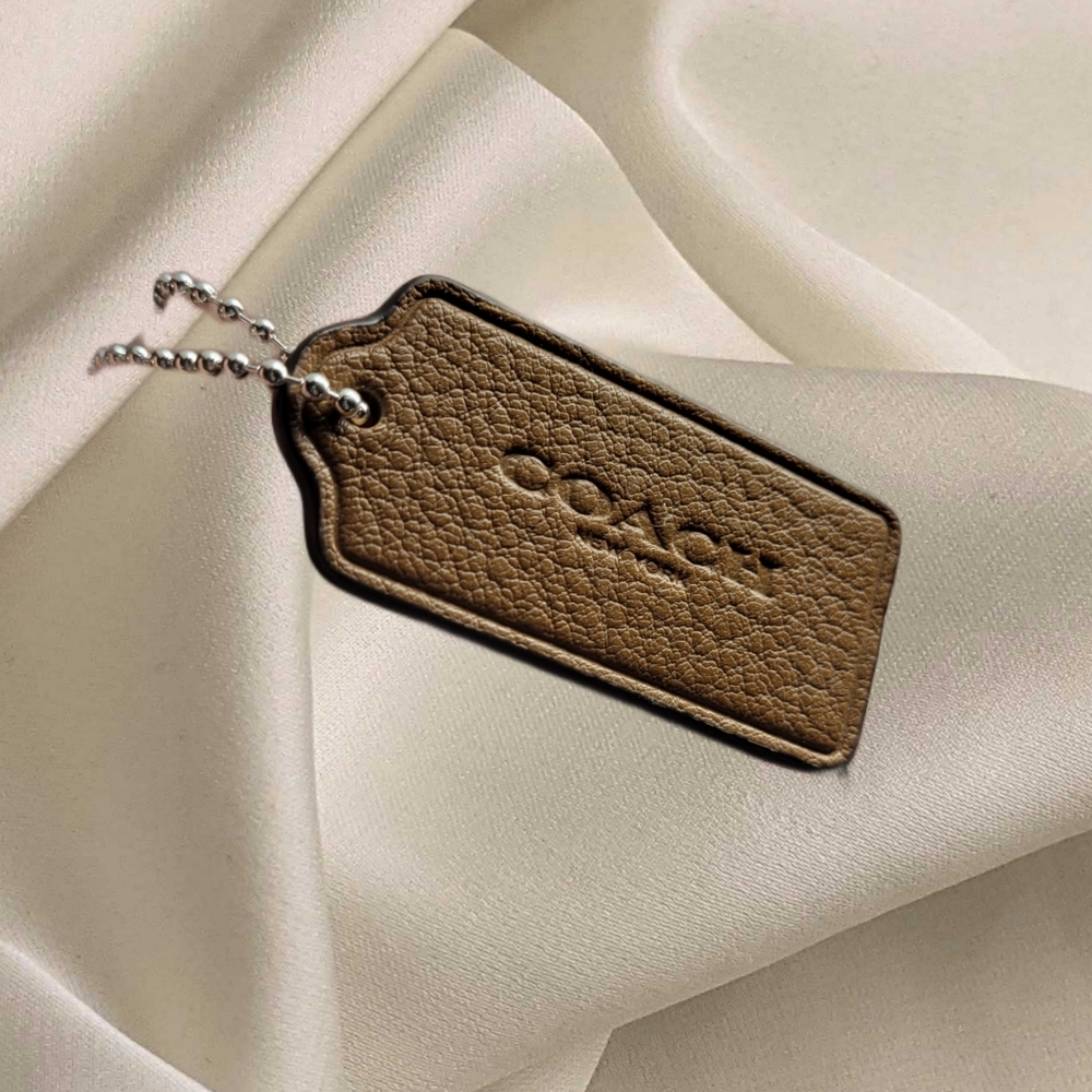 Brown genuine Coach tag on Chain.